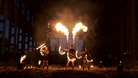 Slow-motion:-Fire-show-in-the-hangar-show-three-female-artist-and-a-man-with-flamethrowers